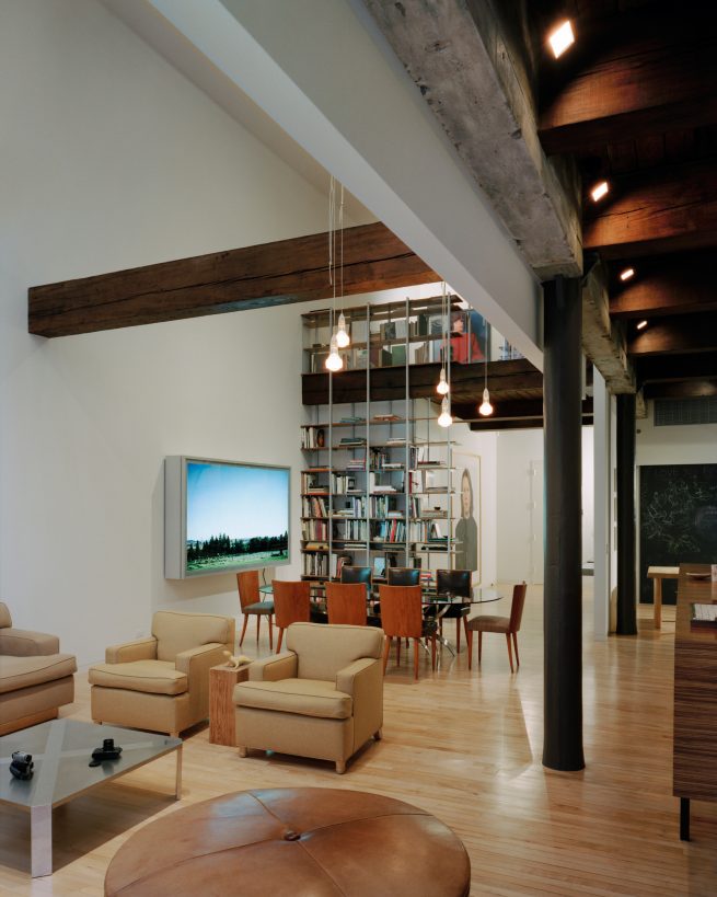 exposed wooden beams cross over open living space