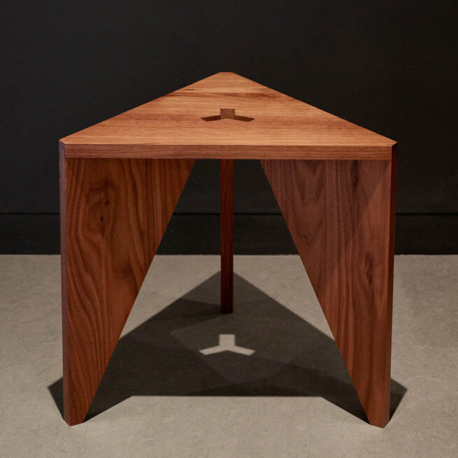 (c) Jason Schmidt. Photograph of a triangular, wooden stool.