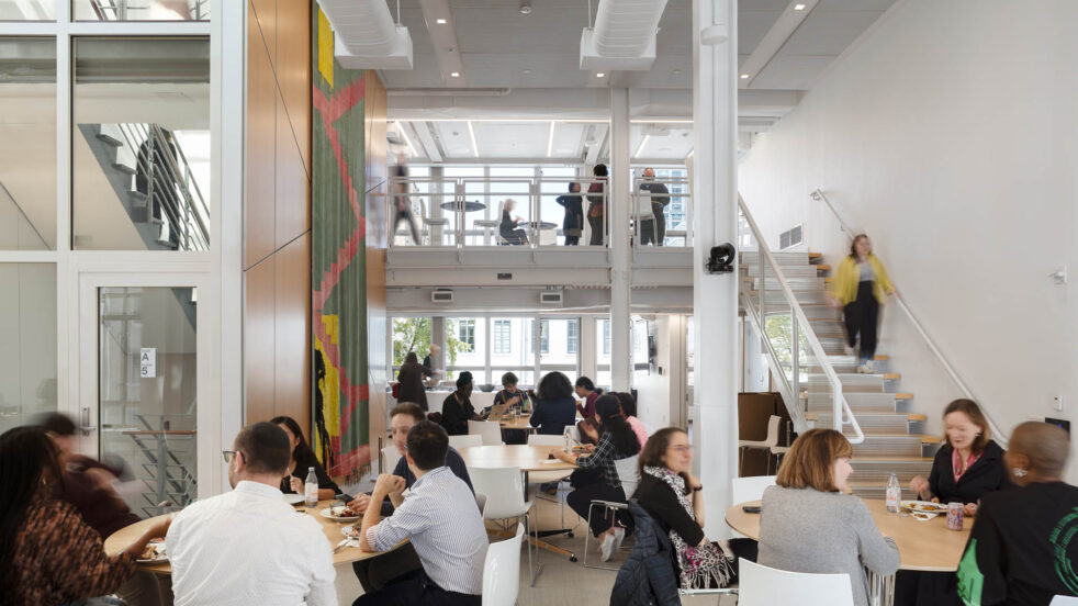 Photograph of Mellon Foundation staff lunch in a double height space. (c) Devon Banks