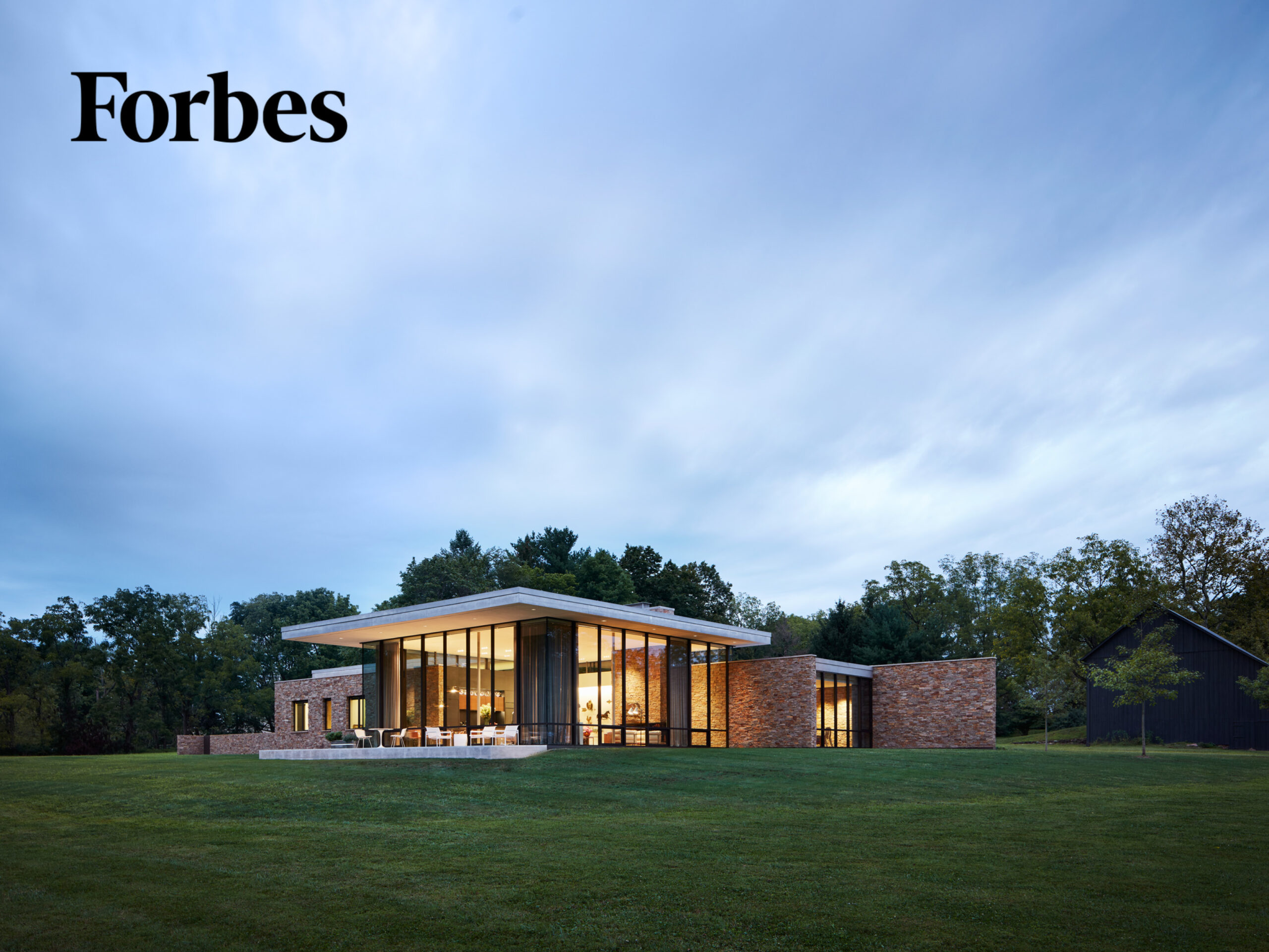 Exterior photo of home with Forbes logo in upper left corner